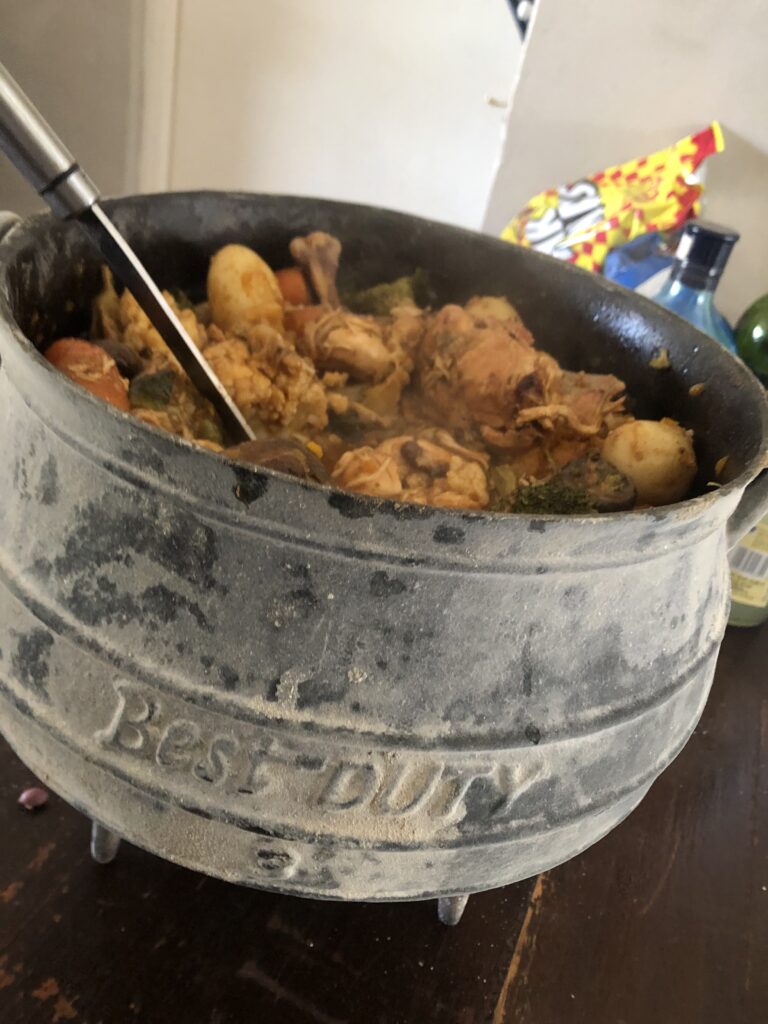 South African traditional stew slow cooked in a cast iron pot over the fire for many hours - POTJIE KOS